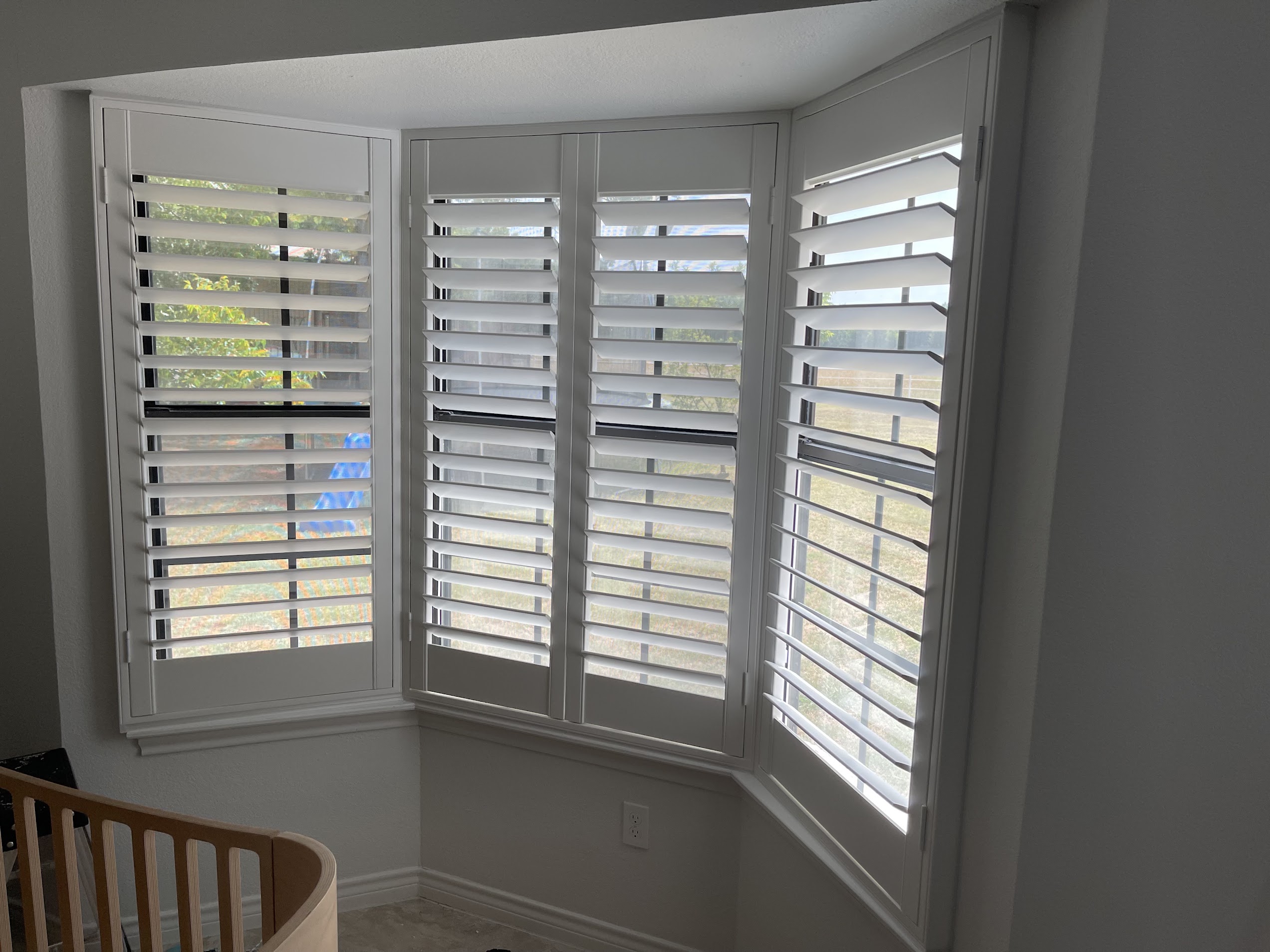 Bay window plantation shutters on a staircase landing