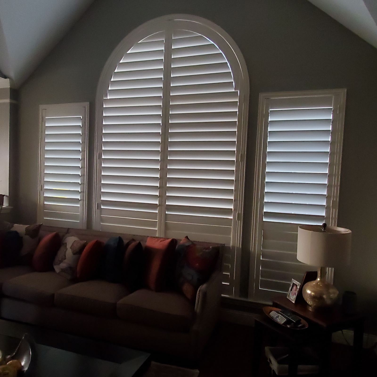 Cathedral arch window plantation shutters in a living room