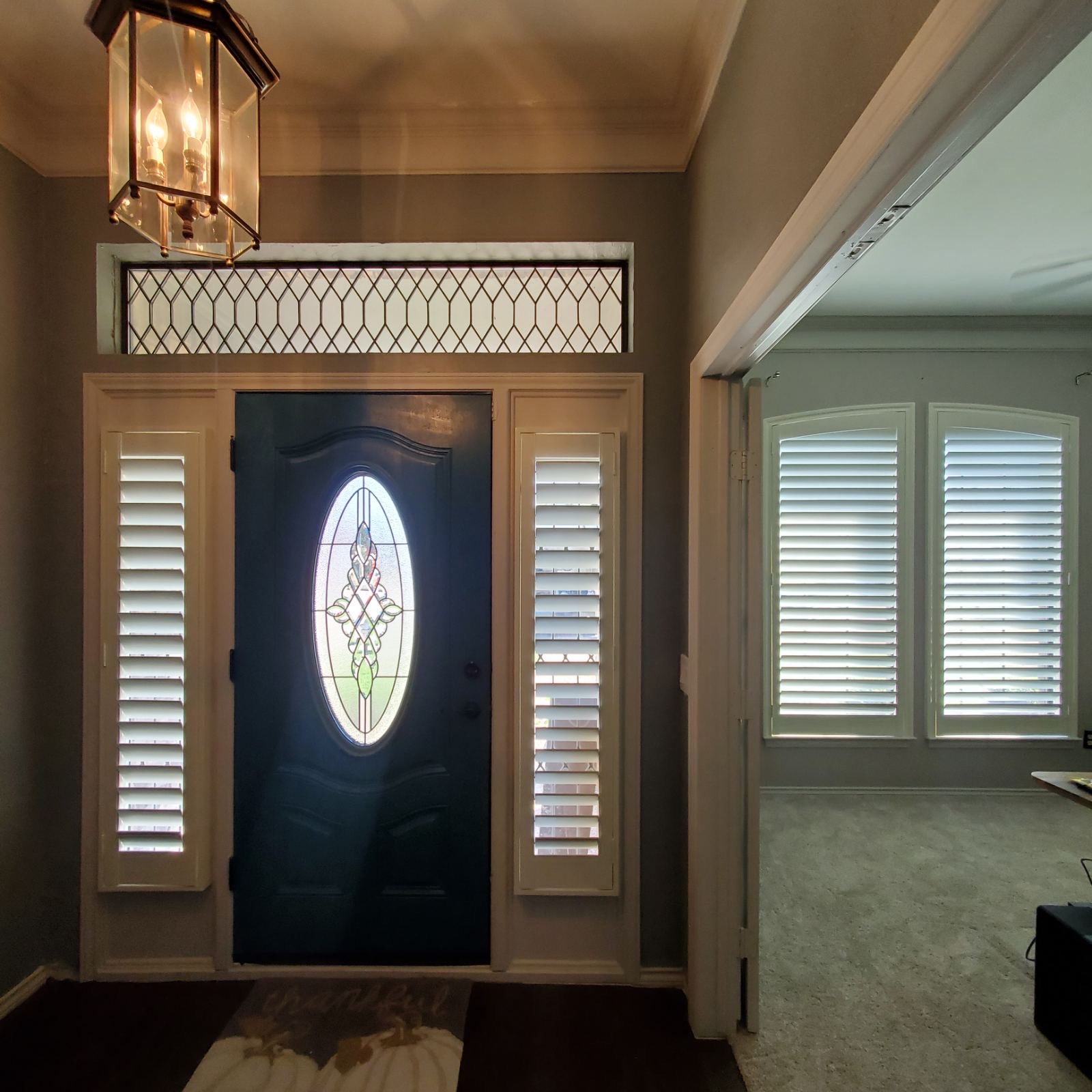 Plantation shutter sidelights framing a front entry door